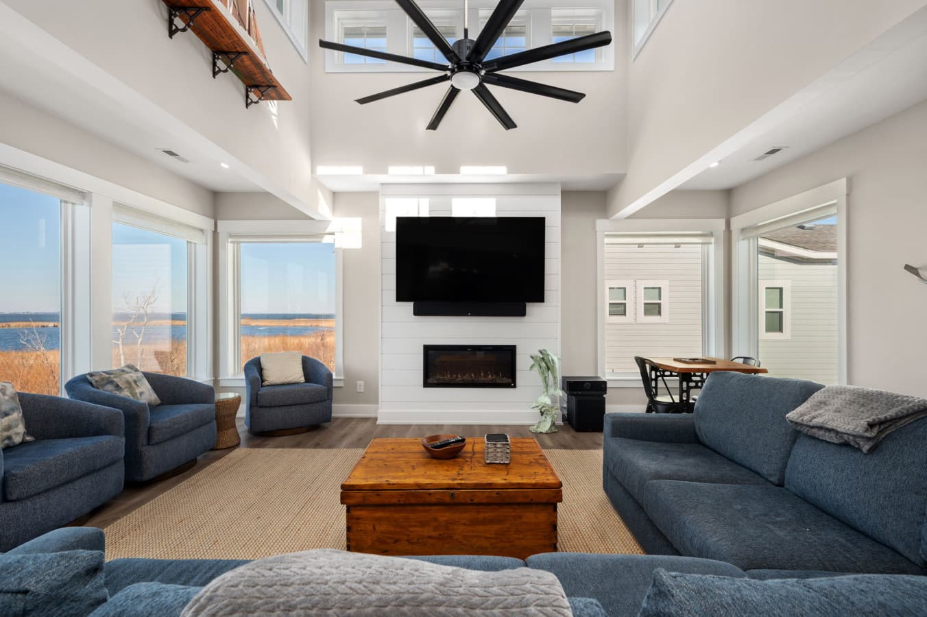 Bright gathering space w/ comfortable sofas, fireplace, & room to relax together indoors