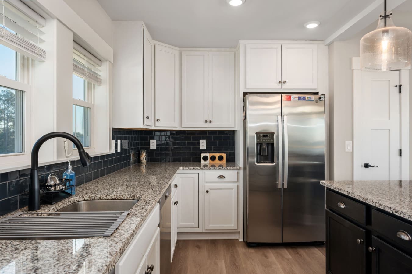 Modern kitchen view w/ stainless appliances & clean lines for easy meal prep