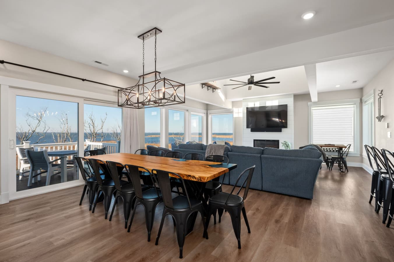 Seamless living & dining layout w/ cozy seating, warm wood tones, & abundant natural light