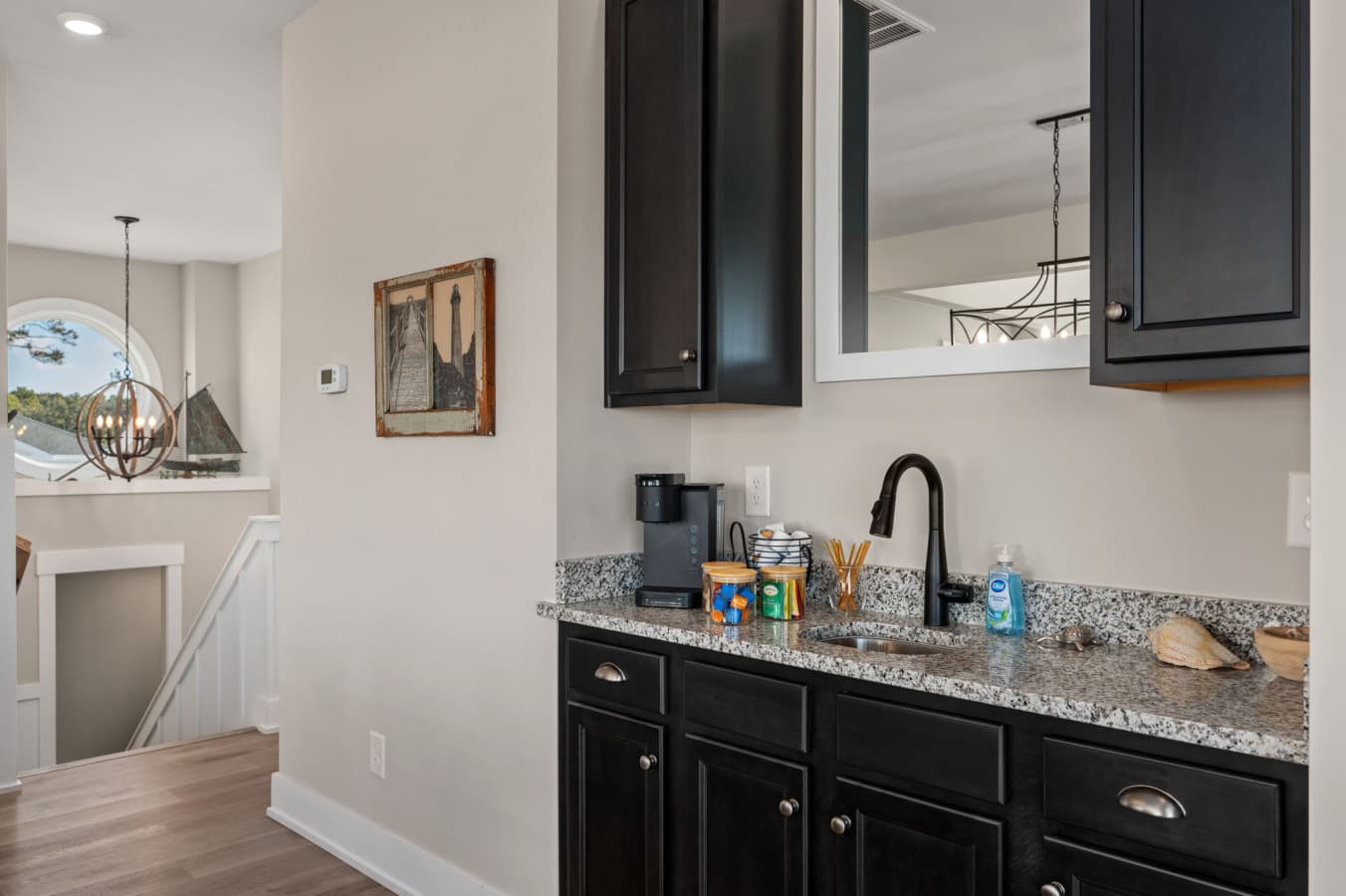 Stylish wet bar w/ sink & storage, ideal for mixing drinks or quick snacks