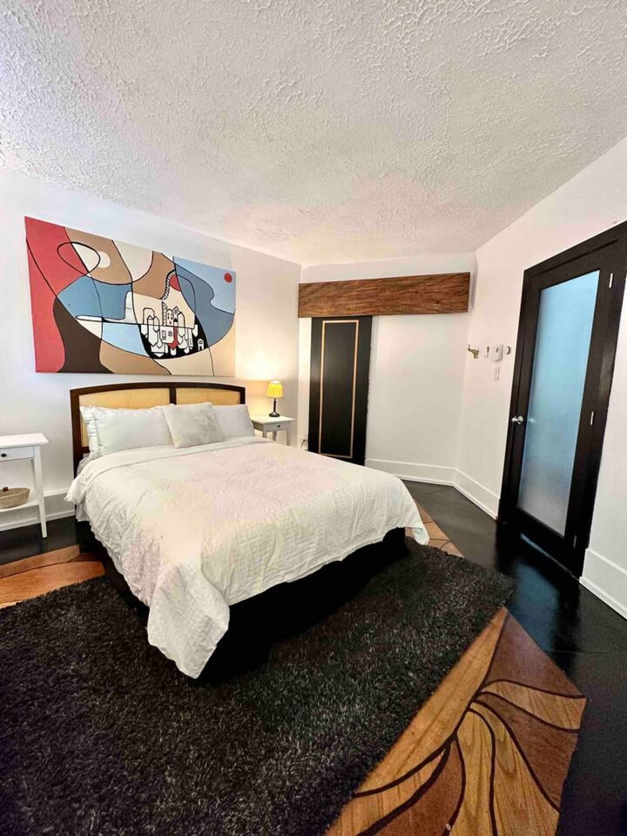 View of the second bedroom, with a large standing desk and spacious dresser