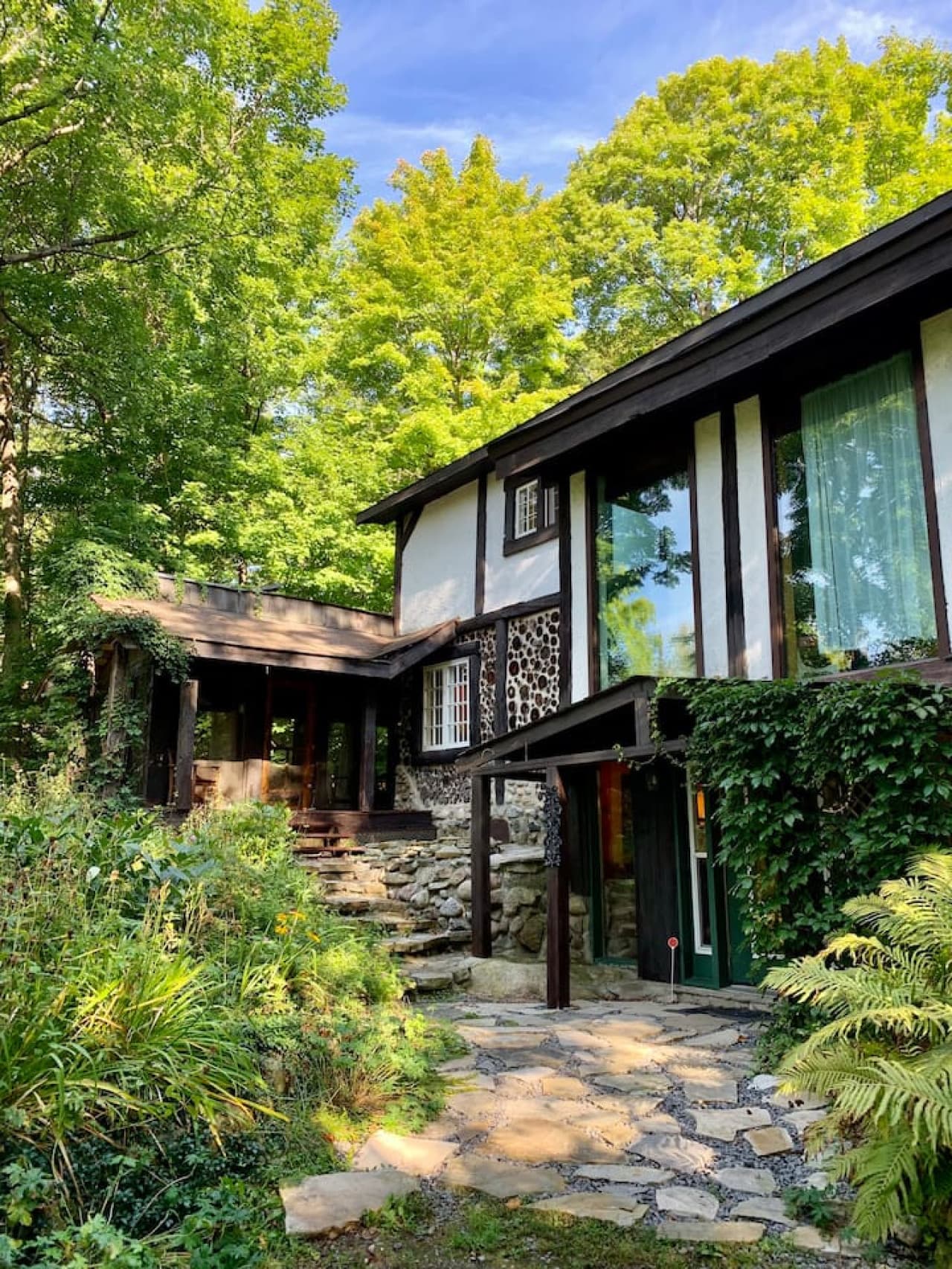 Exterior view of front door, atrium and (left) outdoor living room/gazebo