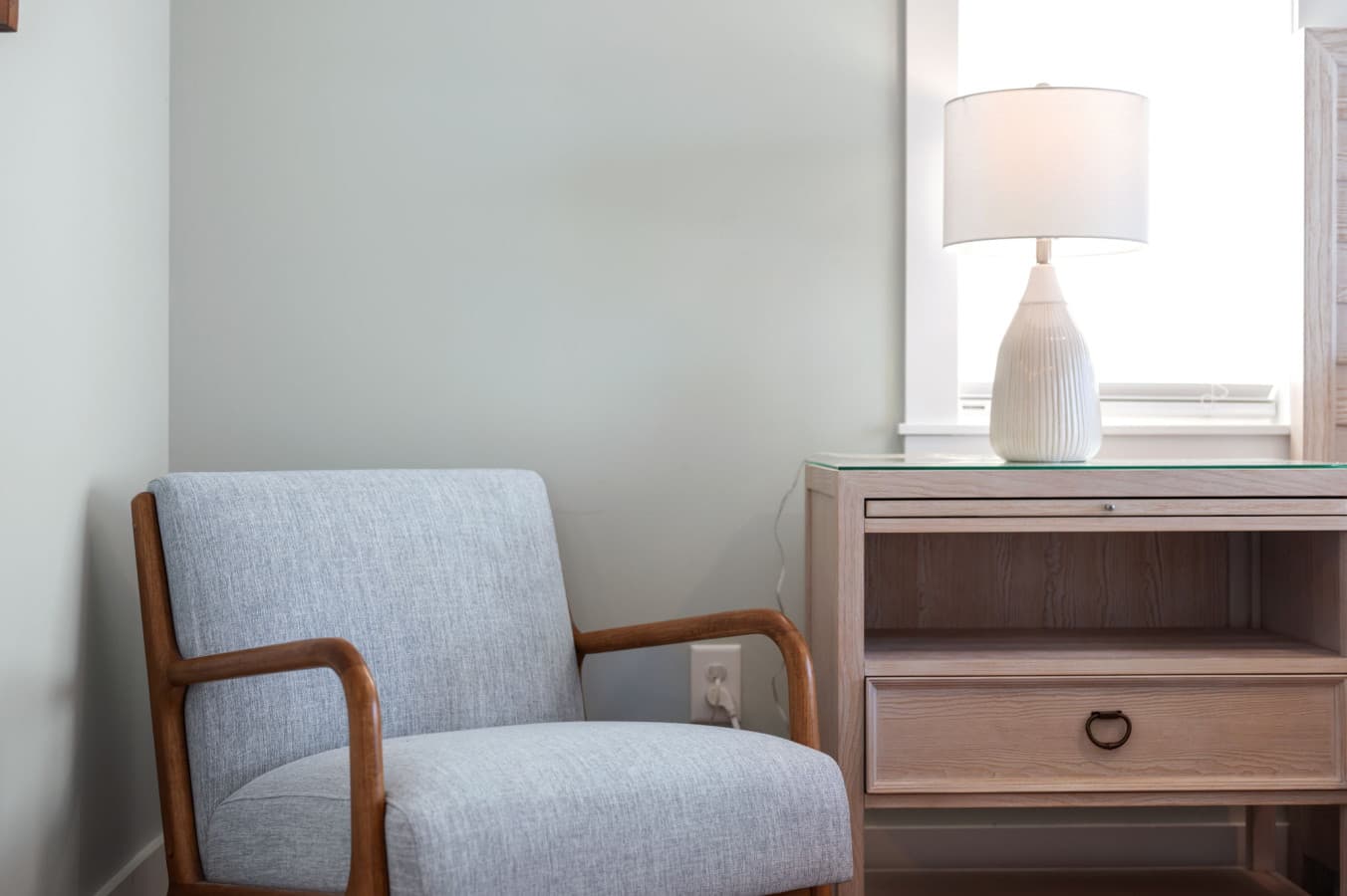 Cozy reading chair & side table tucked by the window for quiet downtime
