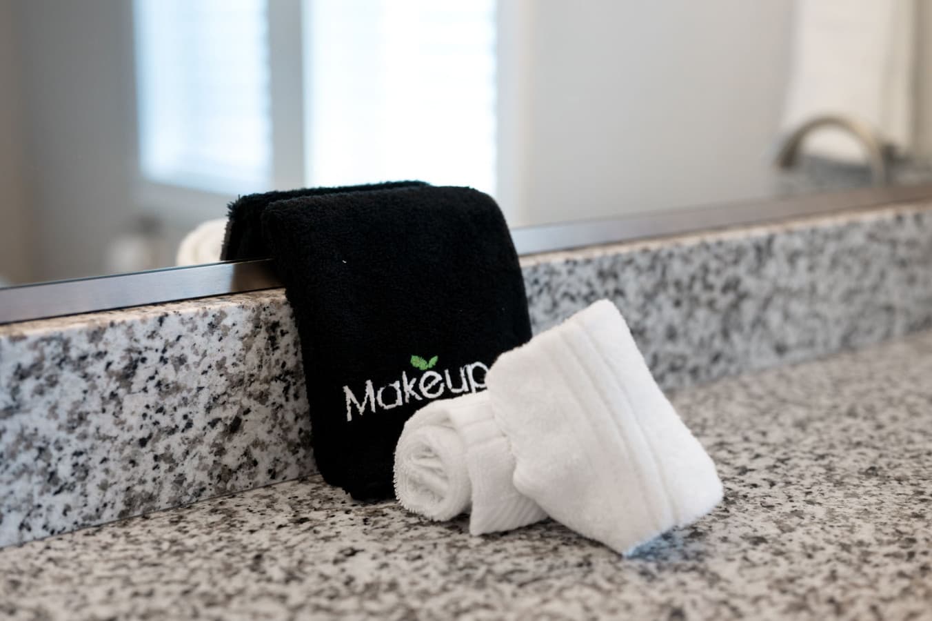 Clean bath details w/ plush towels & simple, modern finishes