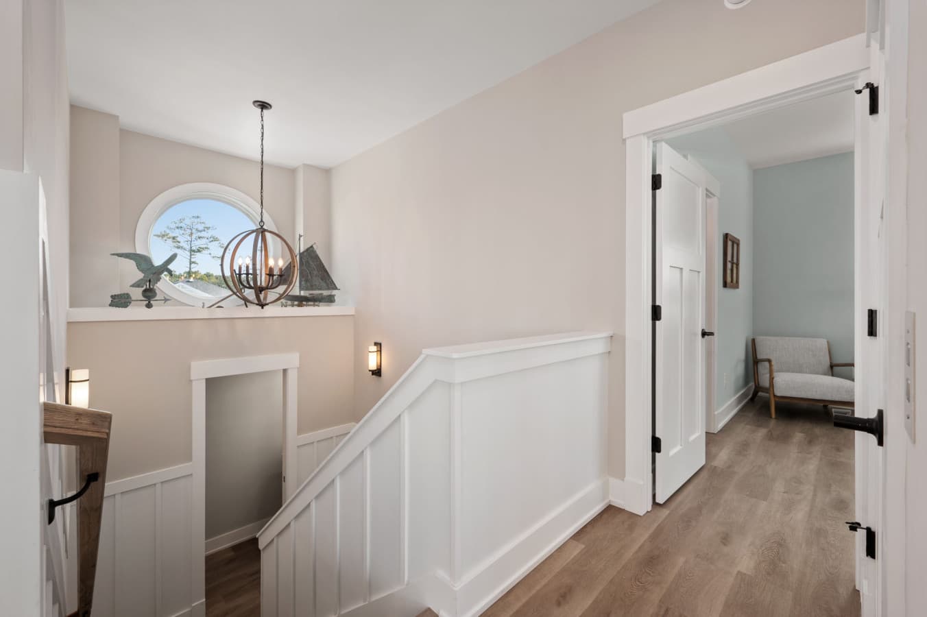 Light-filled landing w/ coastal accents & easy flow between rooms