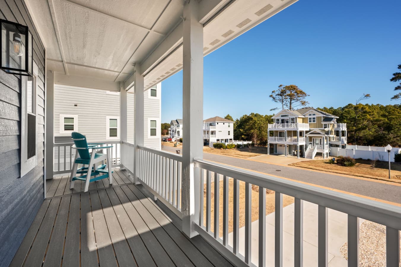 Covered balcony w/ seating, ideal for watching the neighborhood come to life