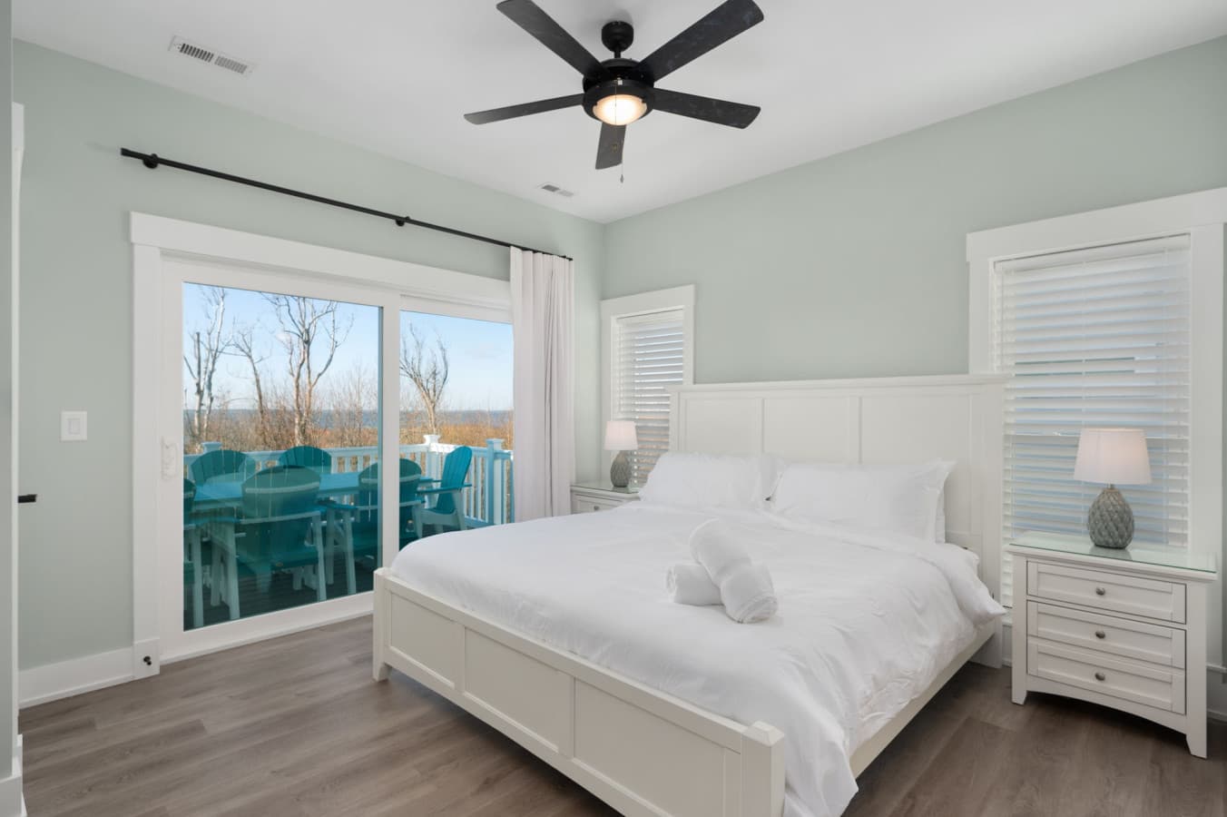 Bright bedroom w/ crisp linens & balcony access for fresh coastal air