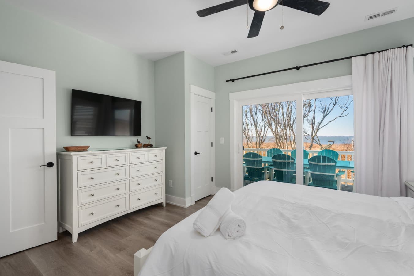 Comfortable bedroom w/ dresser, TV, & peaceful outdoor views