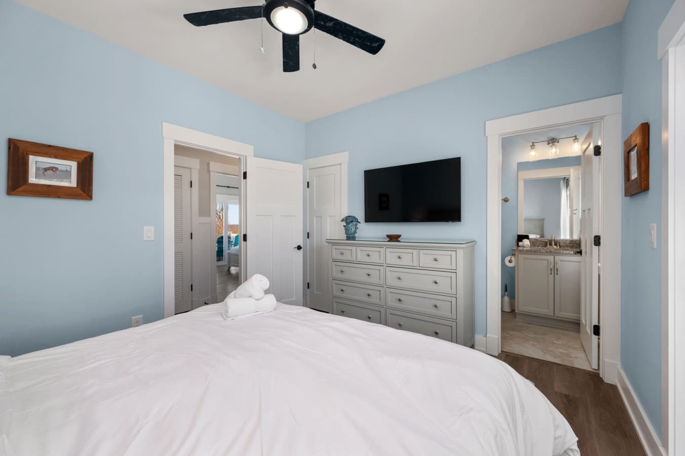 Spacious bedroom w/ dresser, TV, & easy access to the ensuite bath