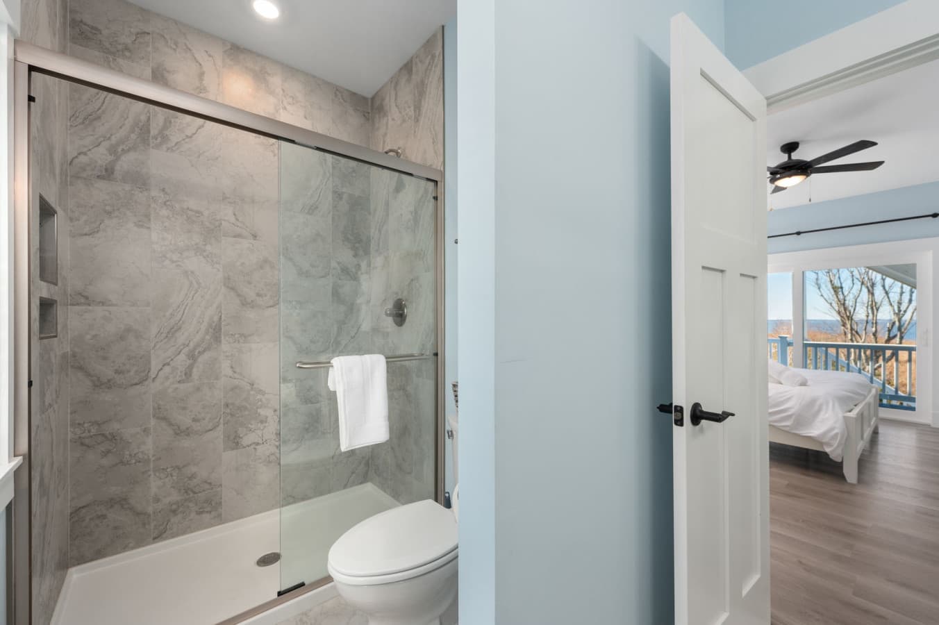 Modern walk-in shower w/ sleek tilework & glass enclosure