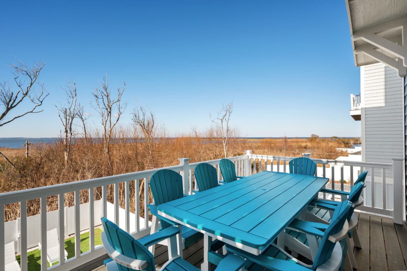 Elevated deck w/ outdoor seating overlooking the water, ideal for morning coffee or sunset drinks