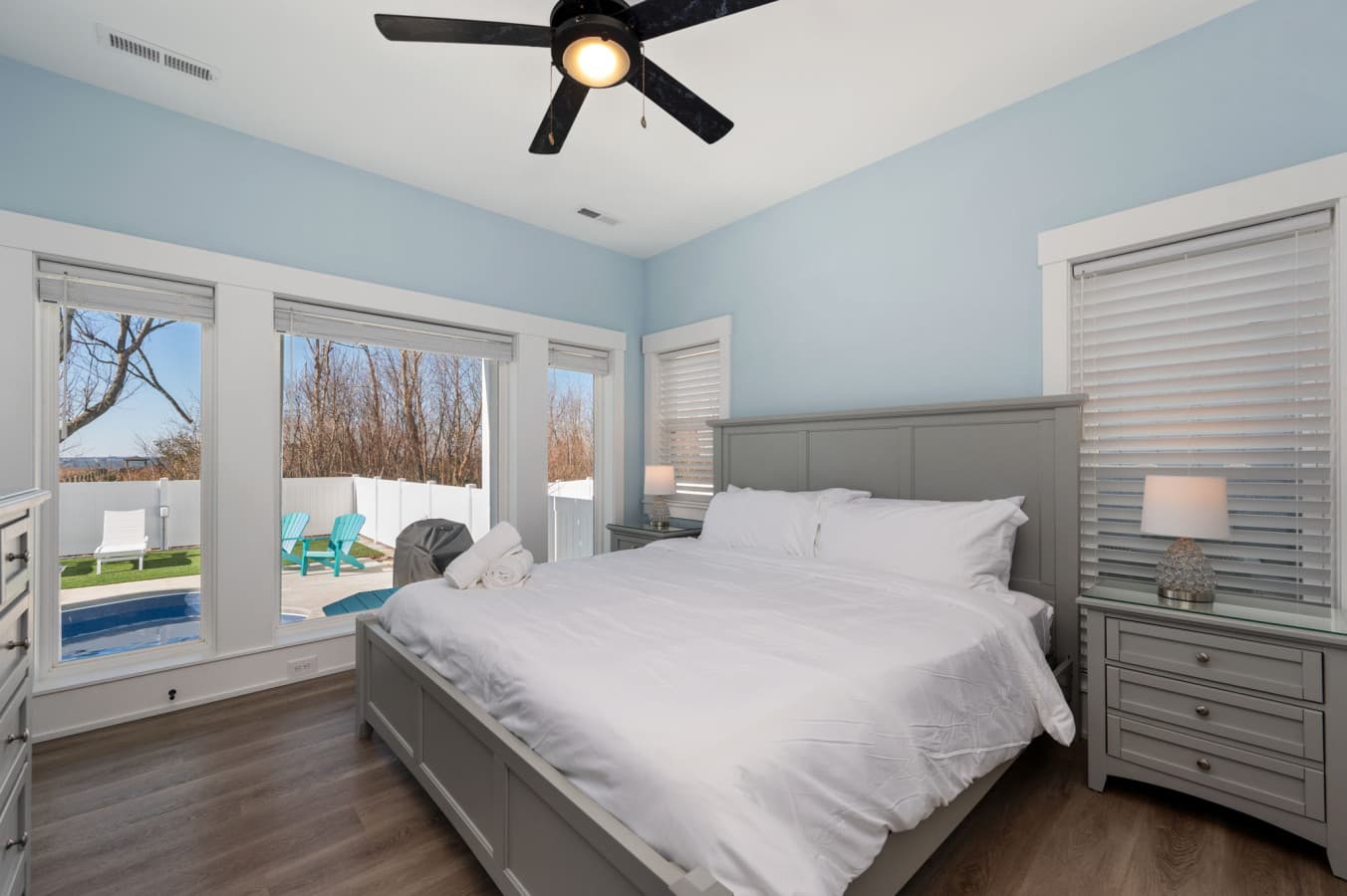 Airy bedroom w/ large windows, natural light, & peaceful outdoor views