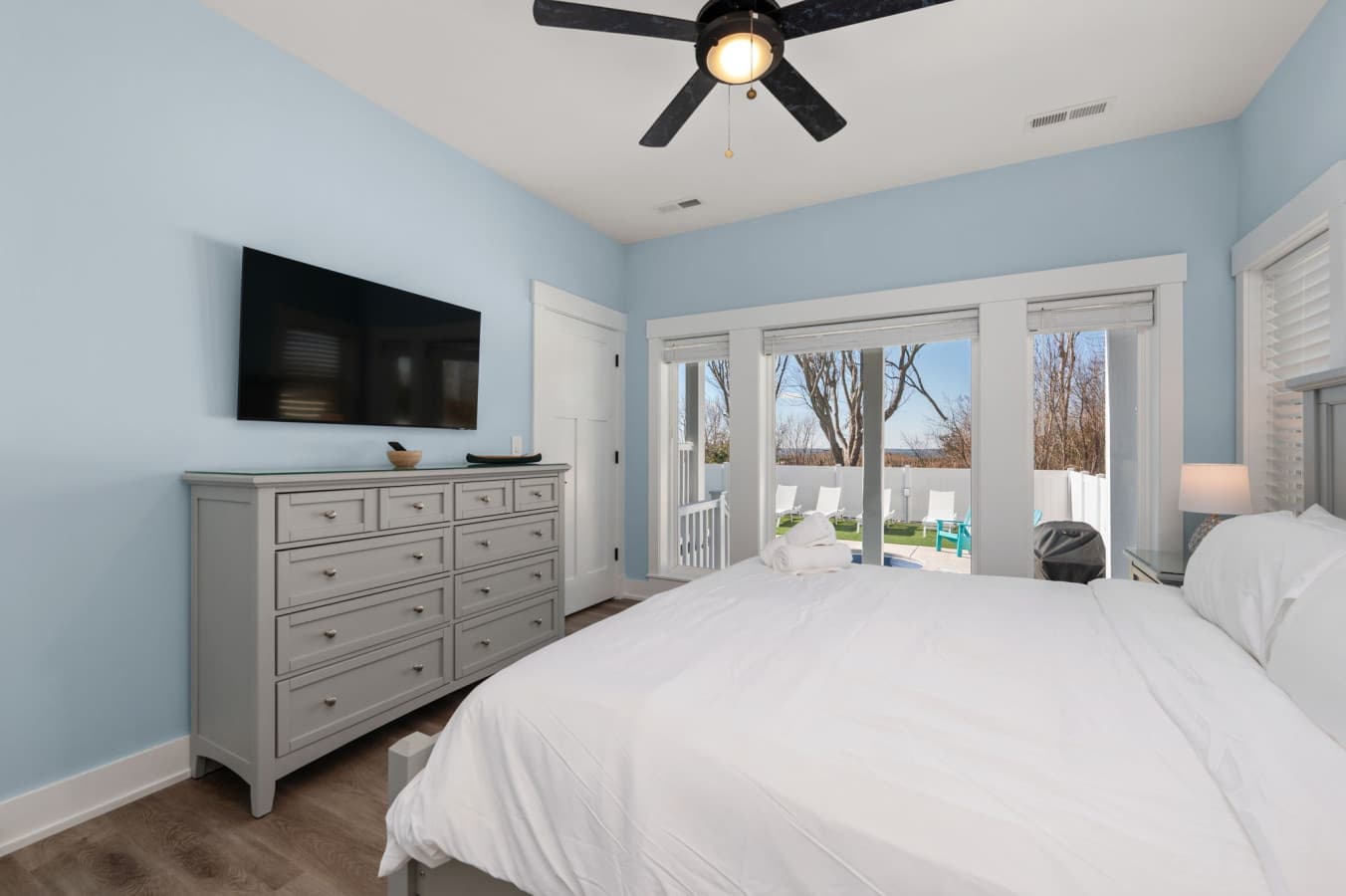 Comfortable bedroom w/ dresser, TV, & soft tones for restful nights