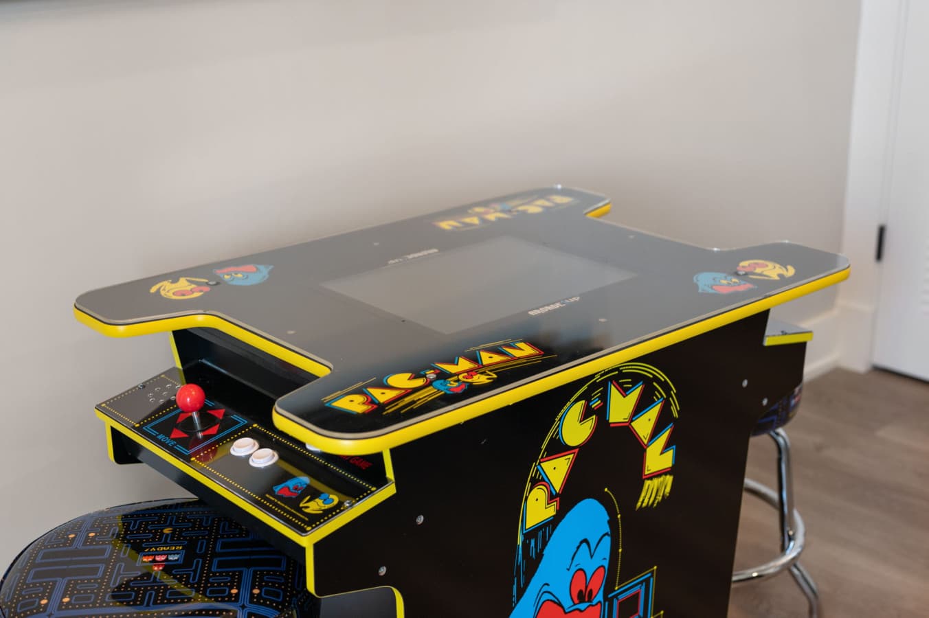 Retro Pac-Man arcade cabinet tucked into the game room for rainy-day tournaments