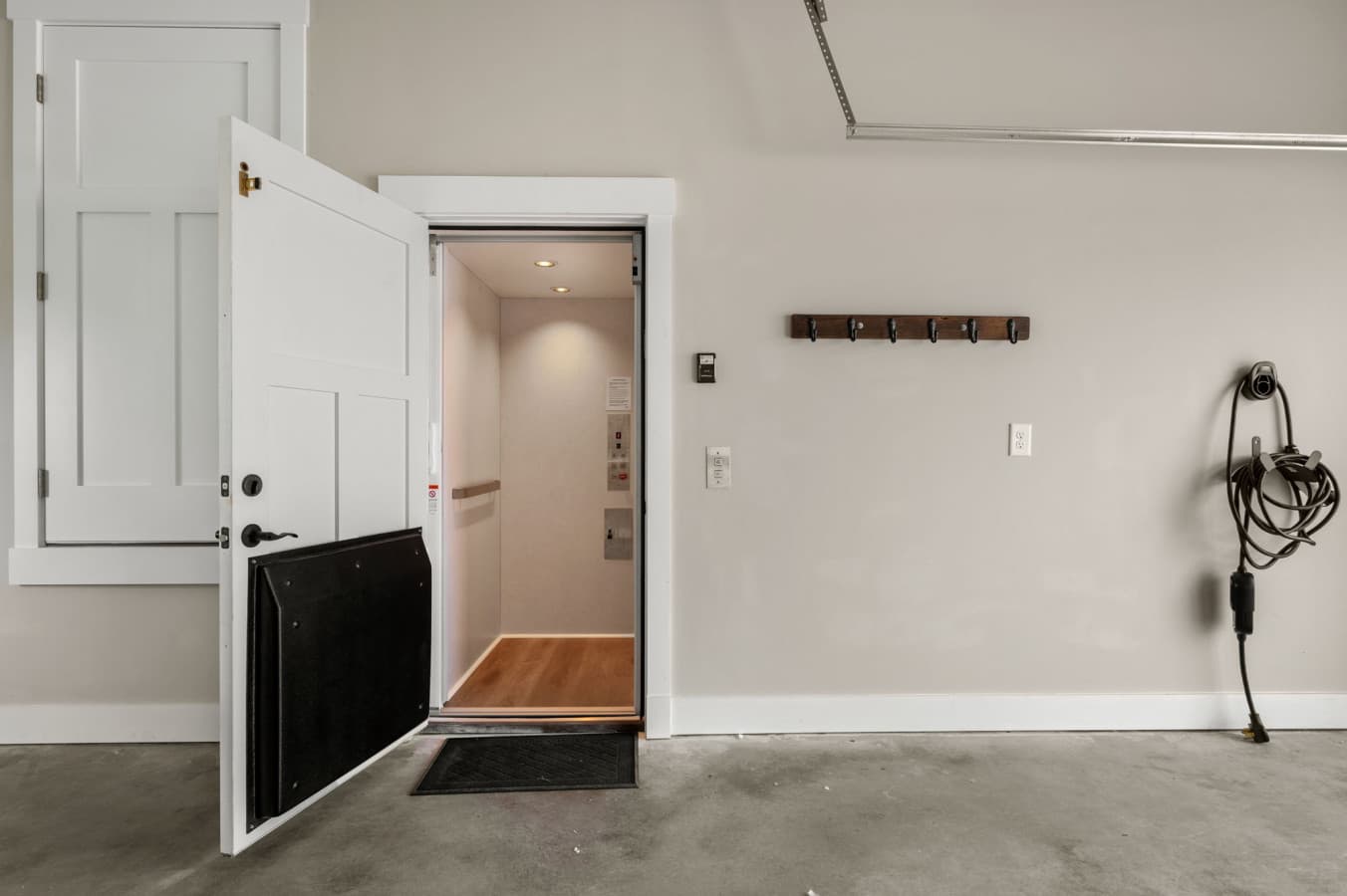 Ground-floor entry w/ coat hooks & a door straight through to the interior stairs