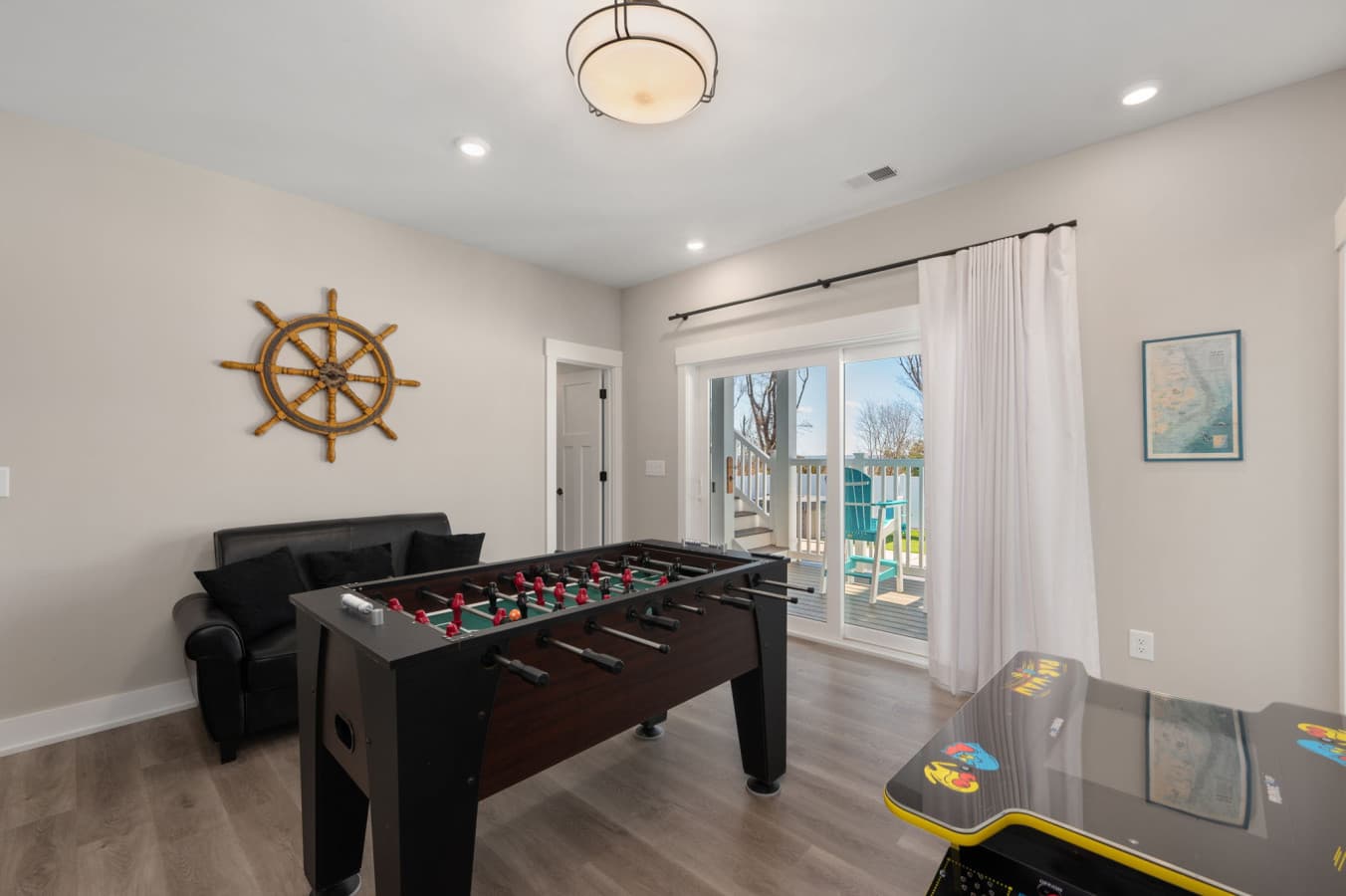 Game room w/ foosball, arcade cabinet & sliders to the deck for easy indoor-outdoor play