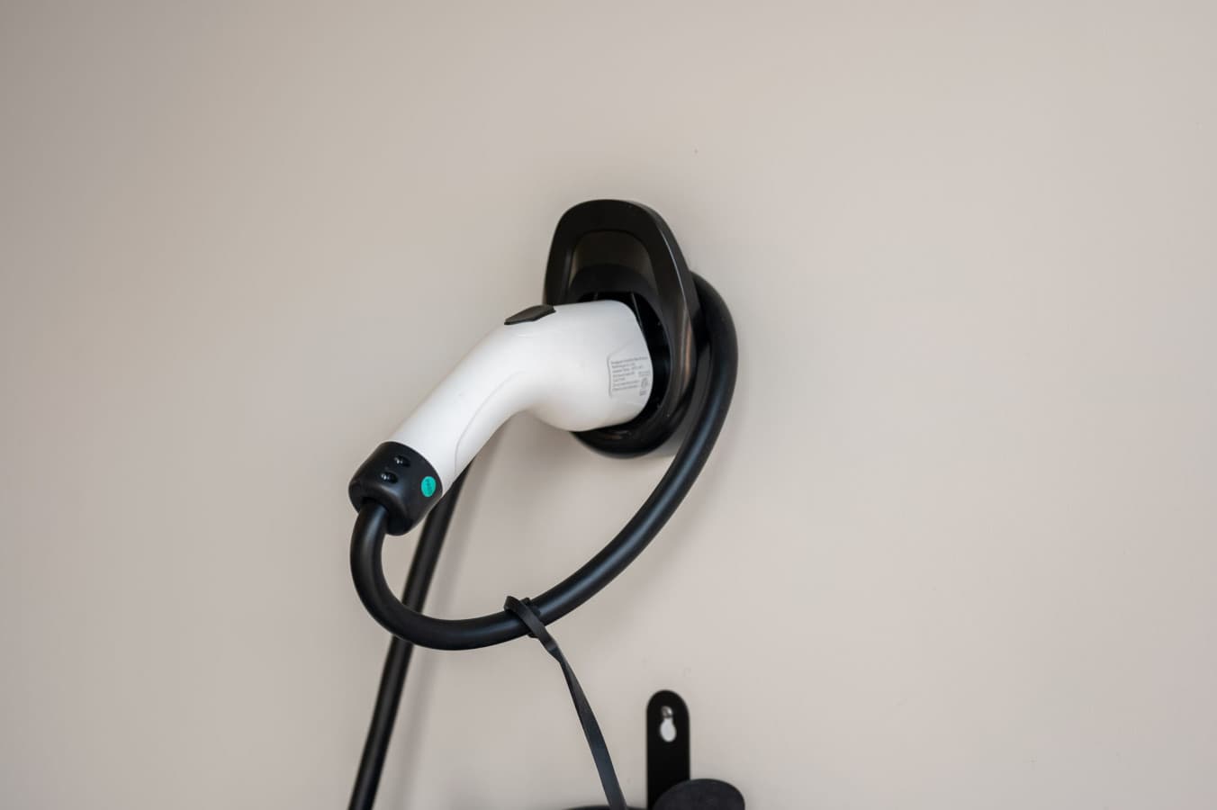 Wall-mounted EV charger on site so electric cars top up overnight