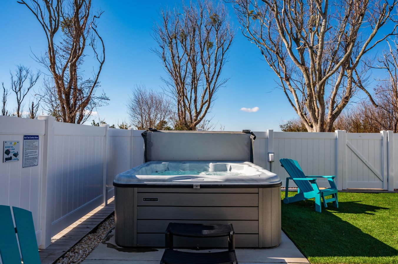 Private hot tub in a fenced nook w/ turf underfoot for a quiet evening soak