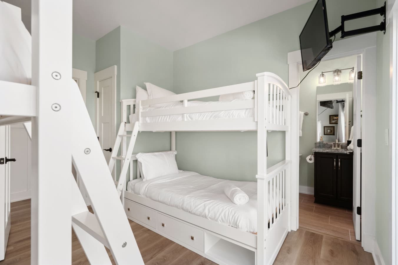 Bunk room w/ twin bunks, wall TV & an ensuite bath just through the doorway