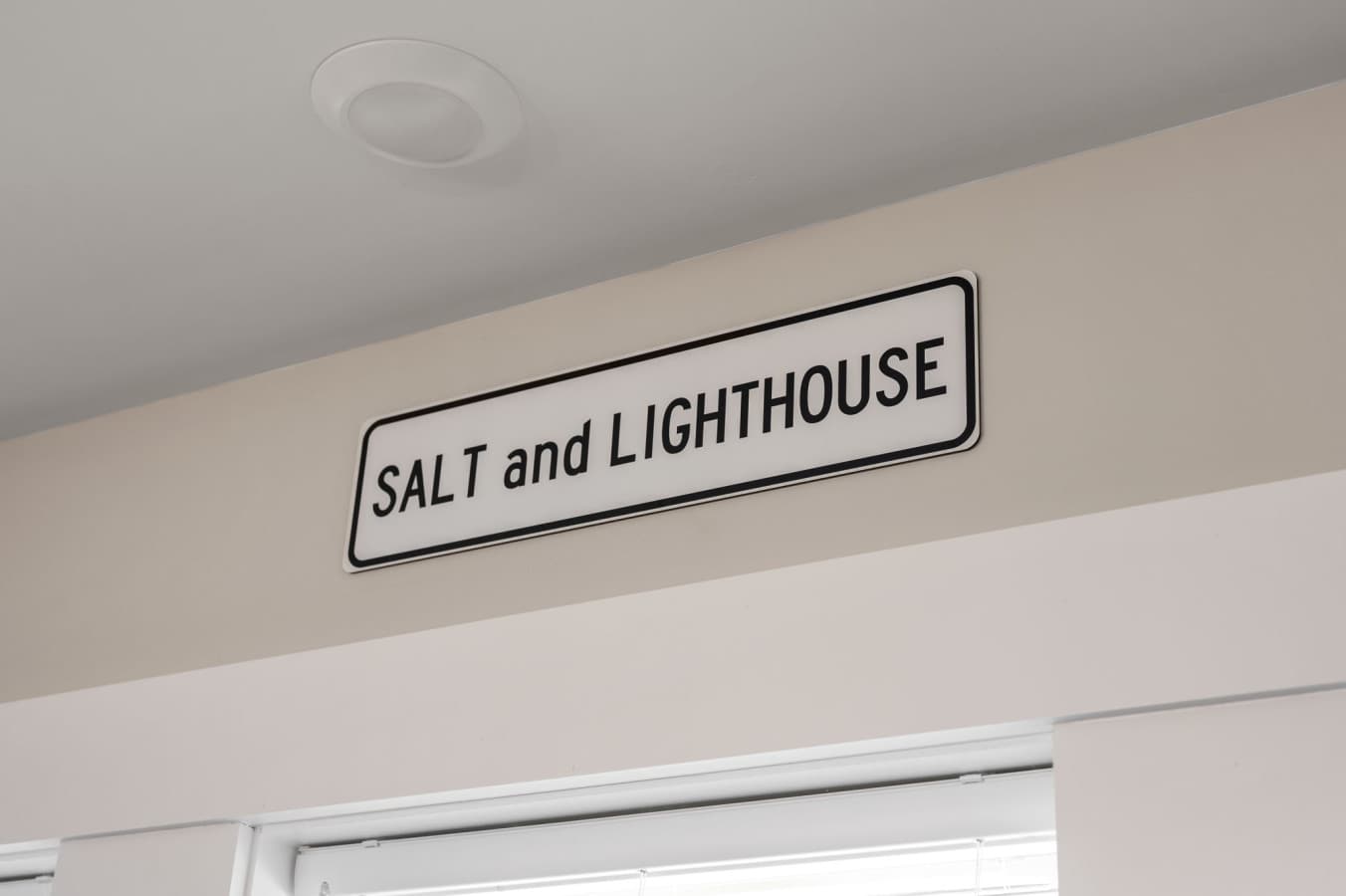 Salt and Lighthouse name sign mounted on the wall as a welcome touch