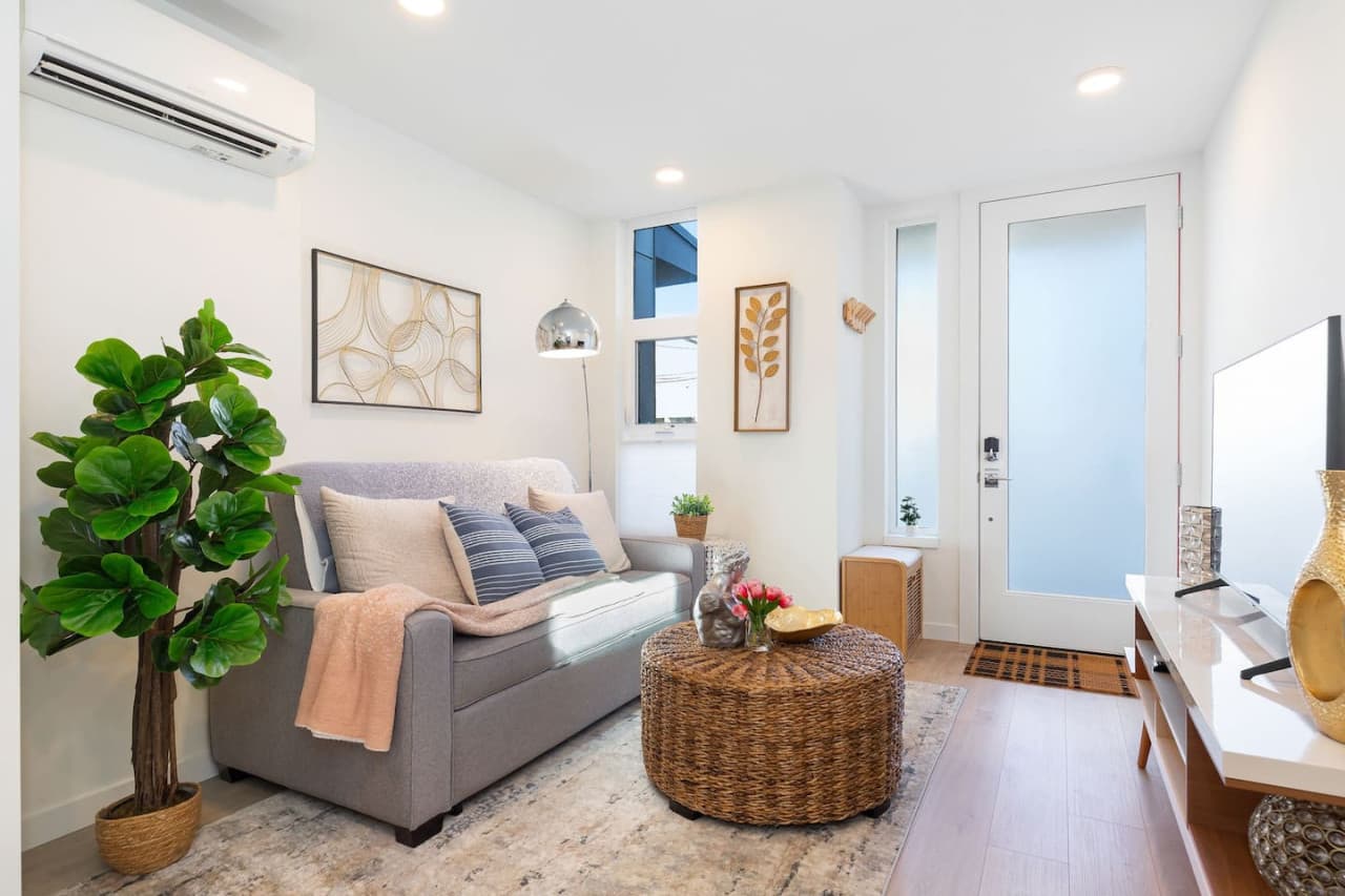 Relax and unwind in the cozy living room, furnished with a TV, a sofa bed, and modern décor. Flooded with natural light, it's perfect for both entertaining guests and quiet nights in.