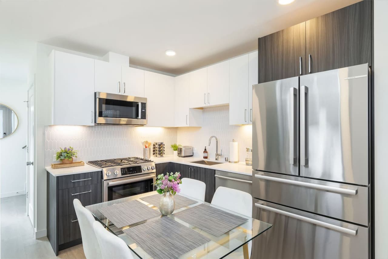 The well-appointed kitchen features ample space for dining, with top-of-the-line appliances and modern finishes to inspire your culinary adventures.