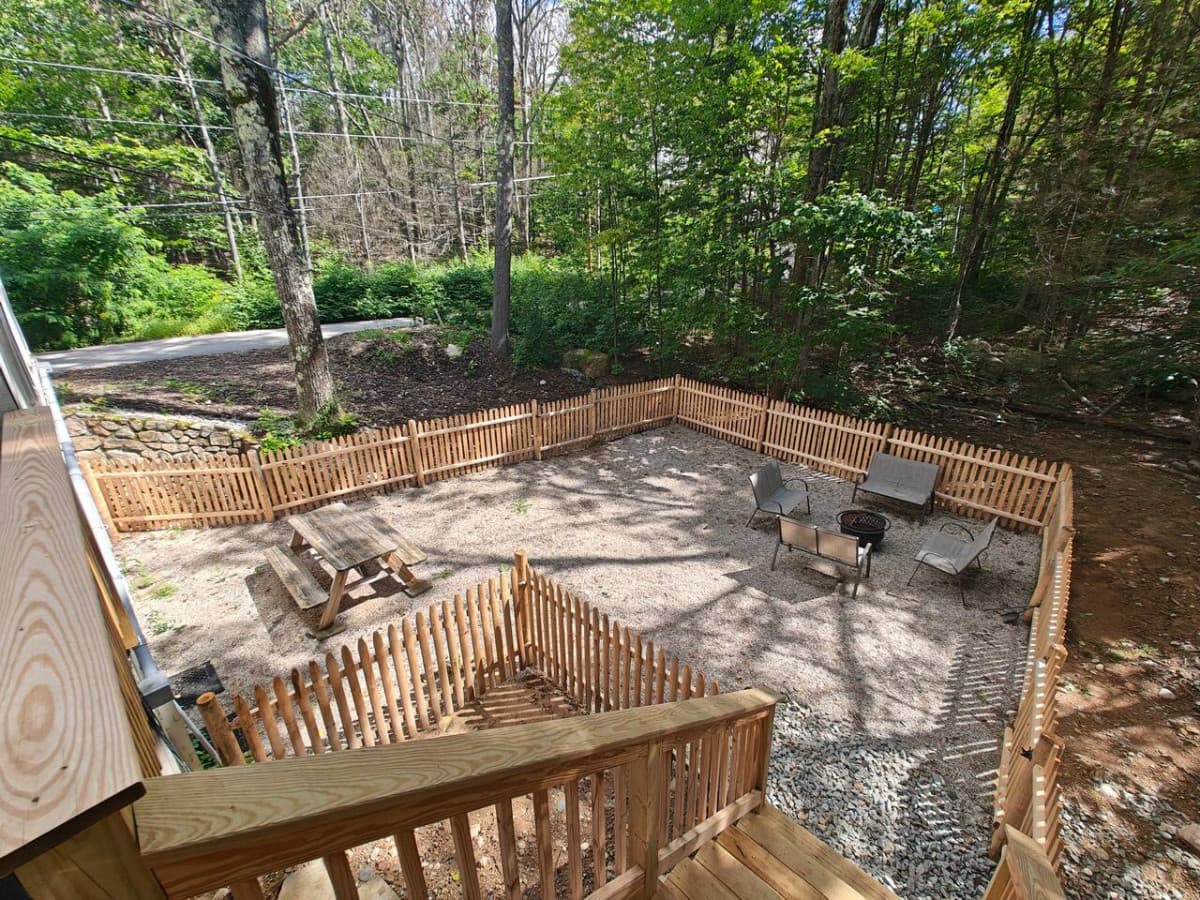Fully fenced yard area off deck with fire pit. Wood supplied for fire pit in garage.