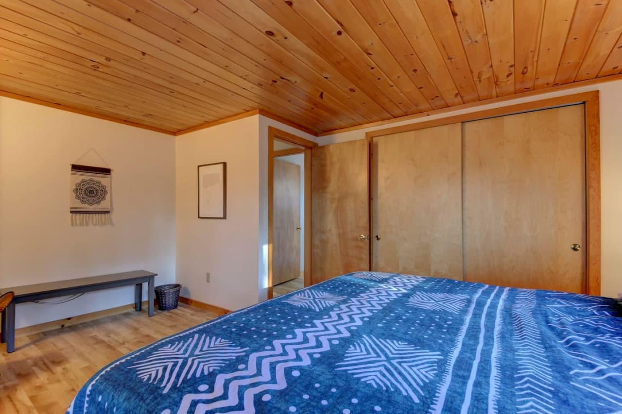 Large closet, bench, and chair in King bedroom