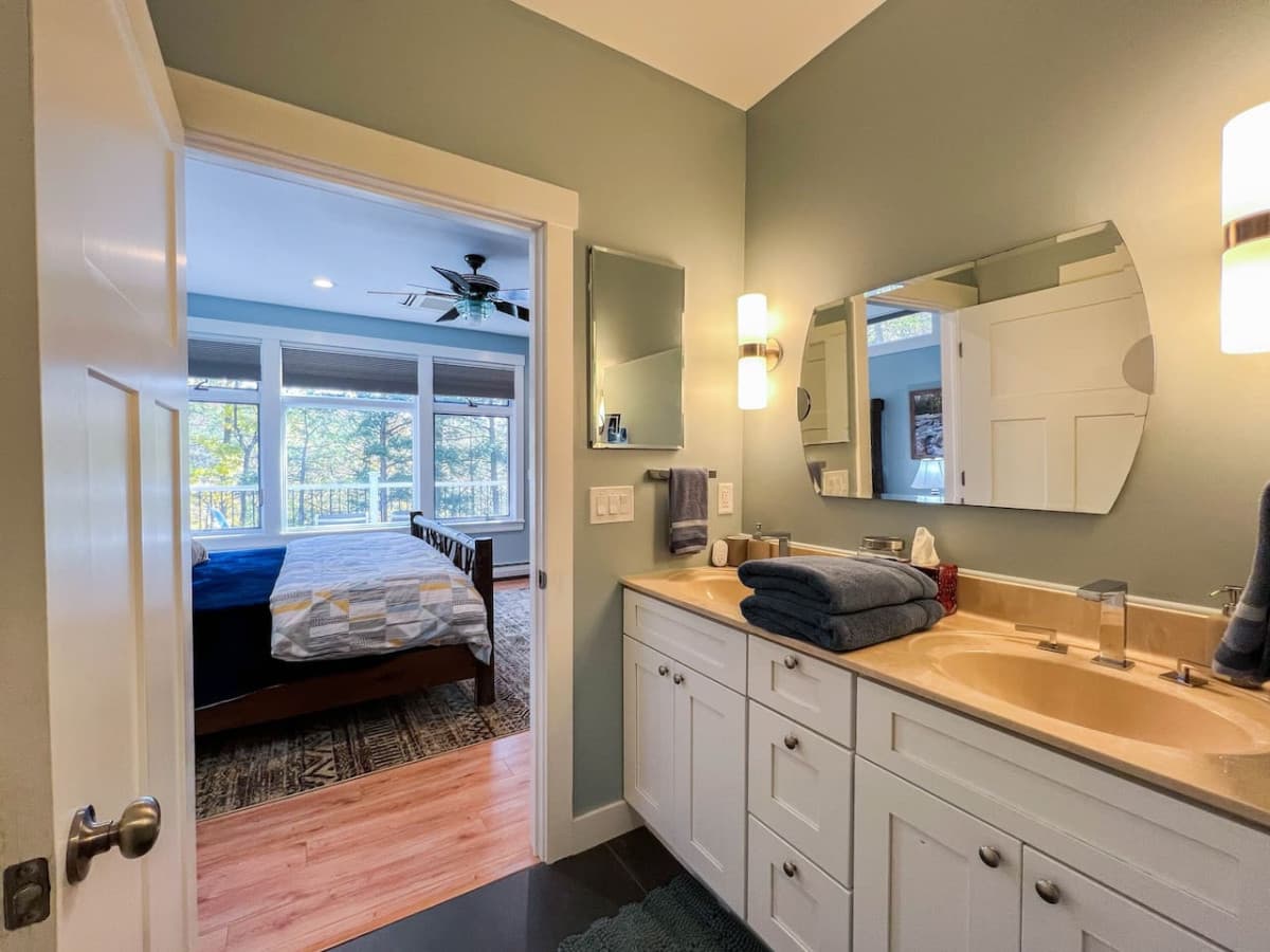 The Master bedroom en suite features dual sinks, a walk-in shower with 3 shower heads, and a large closet with luggage rack.