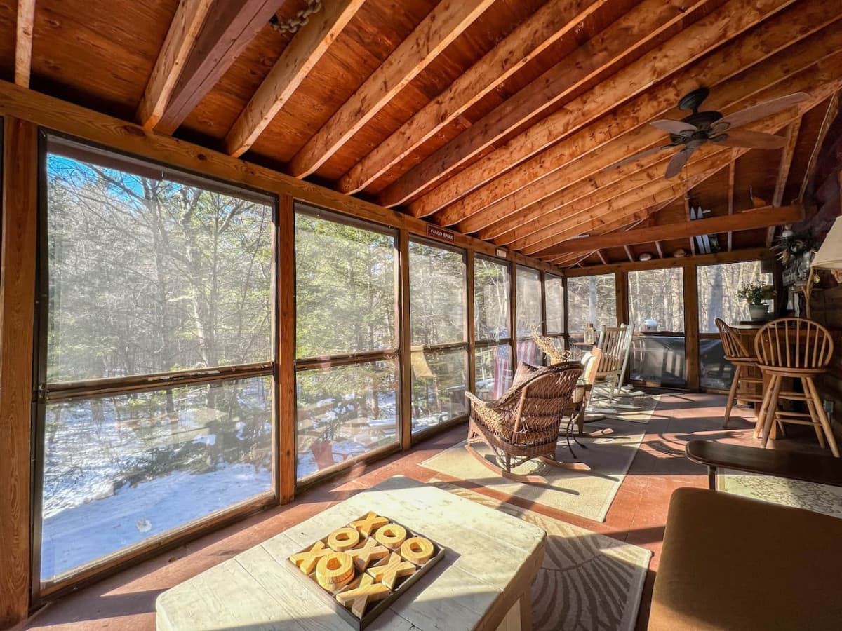 A rare find! A large screened in porch off the rear of the house. Picture shows winterized panels over screens.