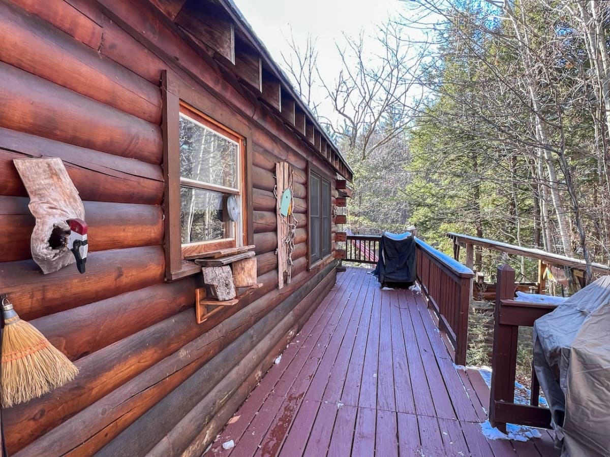 The side porch connects the door near the kitchen, the the screened-in porch (at the end of this photo). There is also interior access to the porch. There is a grill and large picnic table here, plus the stairs to the backyard.