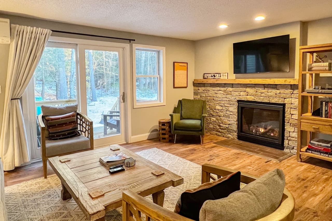 Welcome to Evergreen Haus. The first floor of our townhouse features a cozy living room with a brand-new gas fireplace.