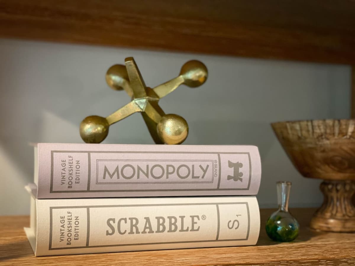 Classic board games in the bookcase and a curated selection of books to read at your leisure.