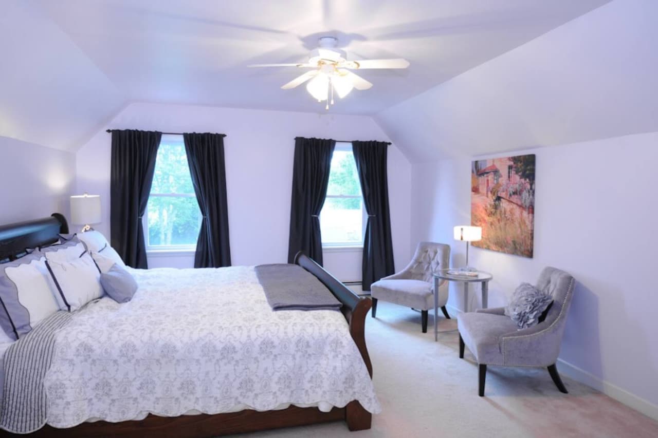 The huge master bedroom on the upper level features a king-size bed, some seating and a large closet. Also, you'll enjoy the access to the ensuite bathroom. In the warm months, a window air conditioner is installed here.