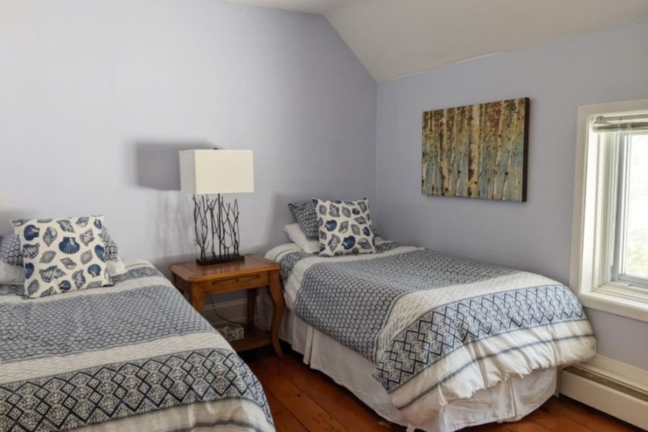Two twin beds in this bedroom. They can be converted into a king bed if this is requested ahead of time. There is also a dresser and ceiling fan.