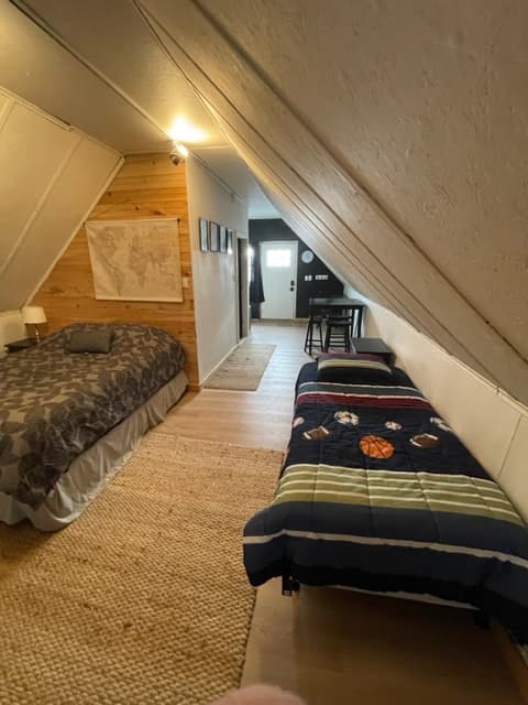 Looking towards the front door Queen bed and Twin, Small table with chairs 