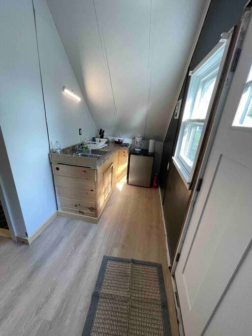 Kitchenette with small fridge/freezer  microwave and kurig
