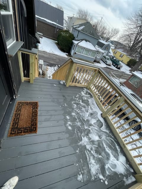Large deck in warmer weather there is a table and chairs outside