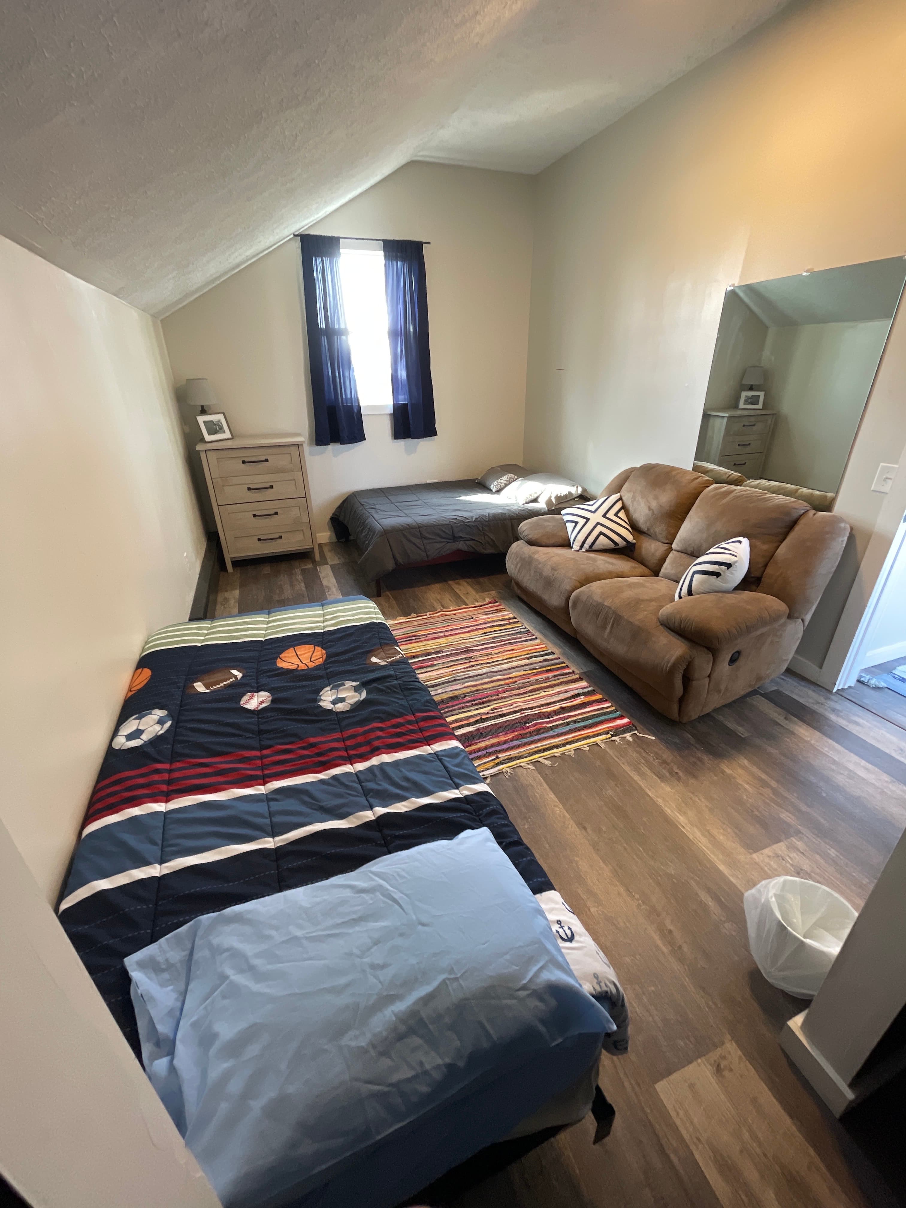One double, one single bed and a couch 