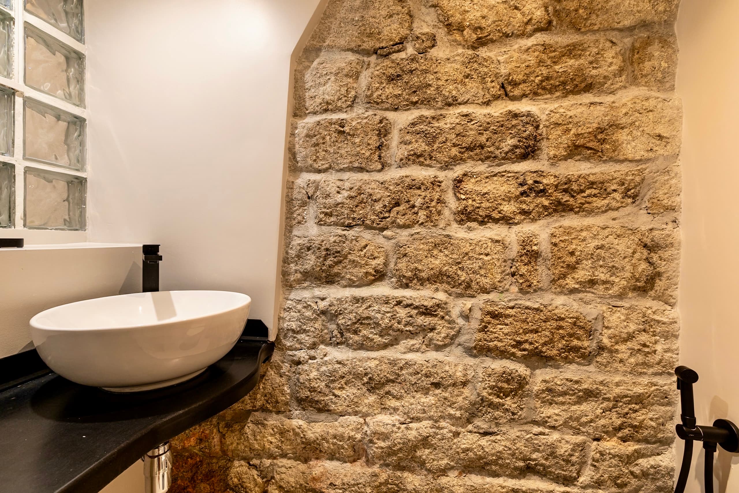 Half-bathroom on the ground floor with exposed brick