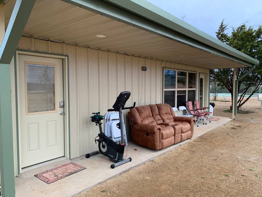Lake Godstone Field House Porch entrance seating and exercise bike.