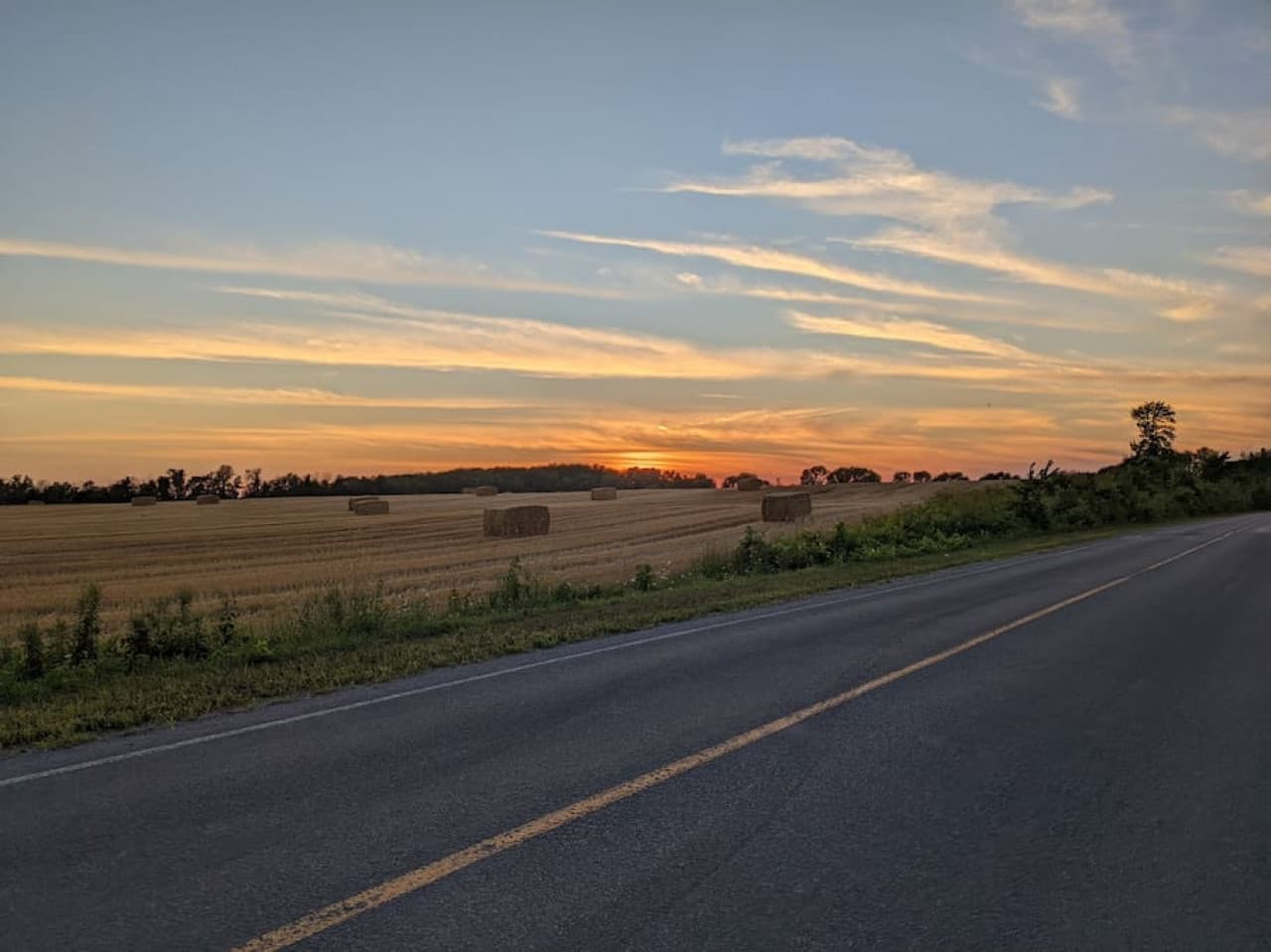 Biking on the county road with the majestic sunset