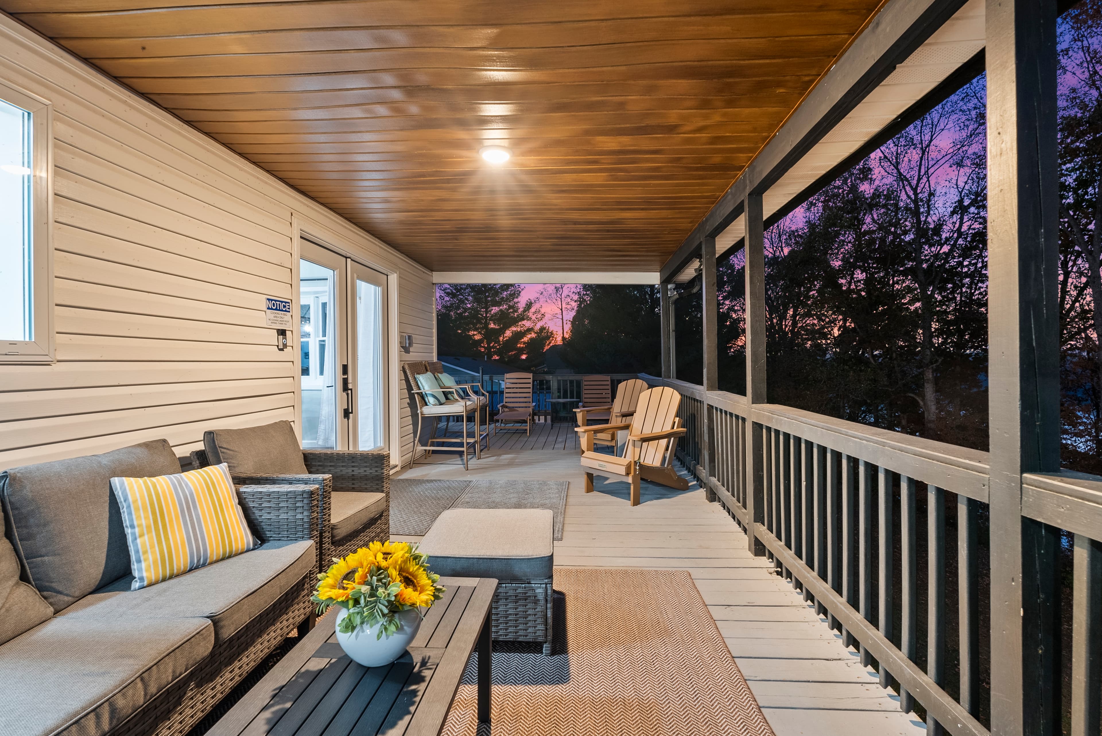 Directly outdoors from the kitchen/dining area you will find this comfortable outdoor retreat w/view