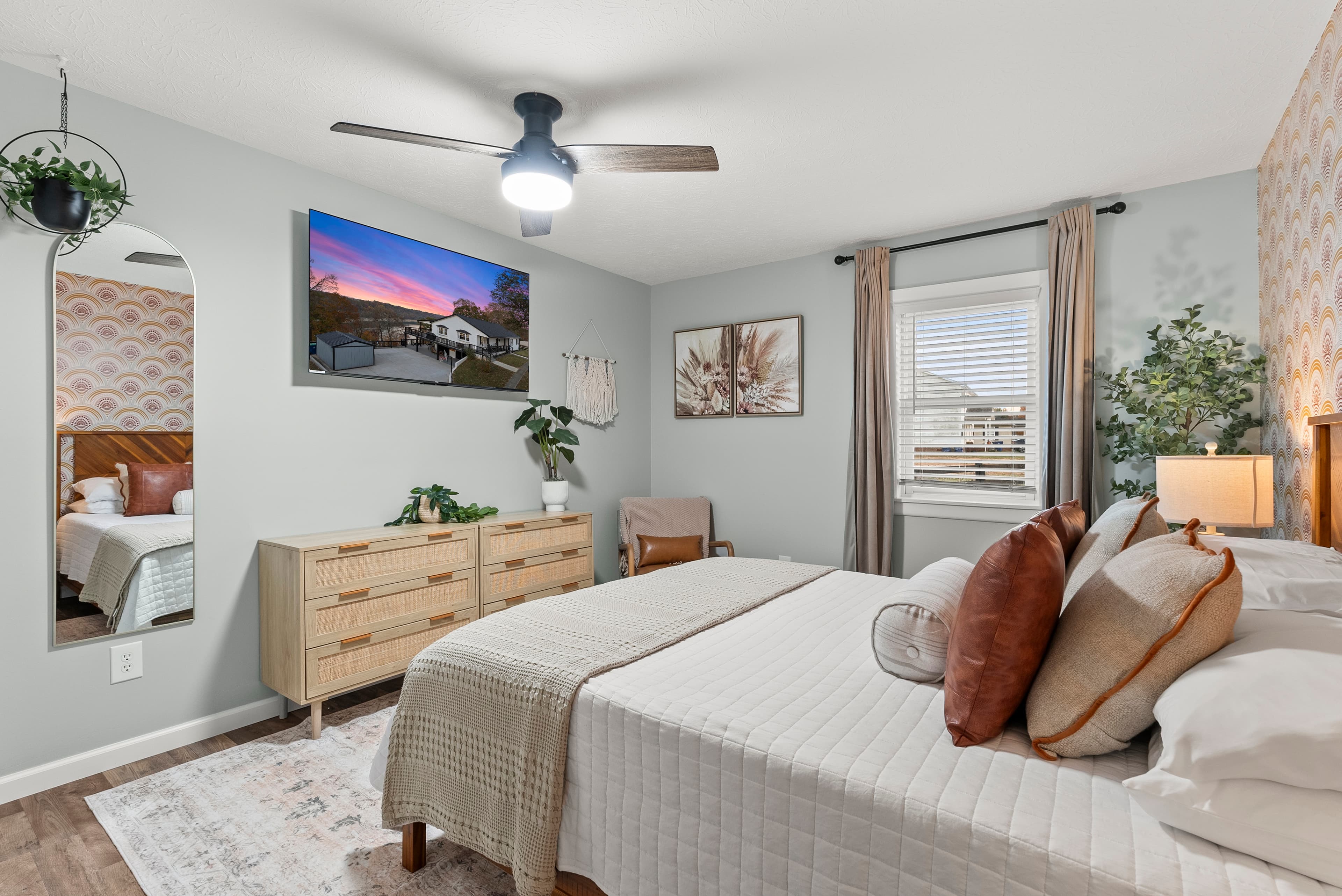 Main level west "Boho Bedroom" w/queen sized bed, dressers, night stands w/lamps and lounge chair