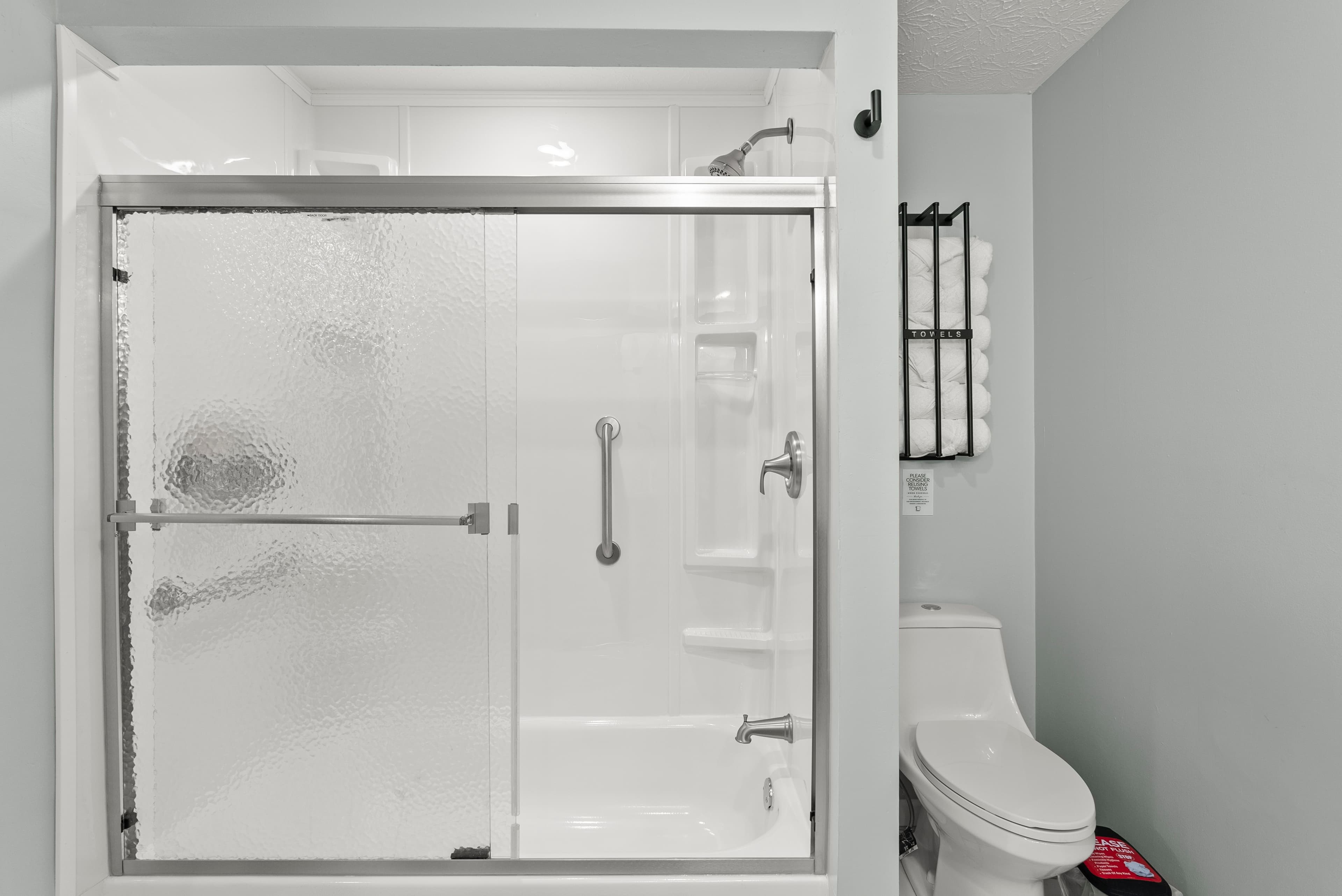 Shower / tub combo main level hall bathroom that services the "Boho" and "Blush"queen sized bedrooms