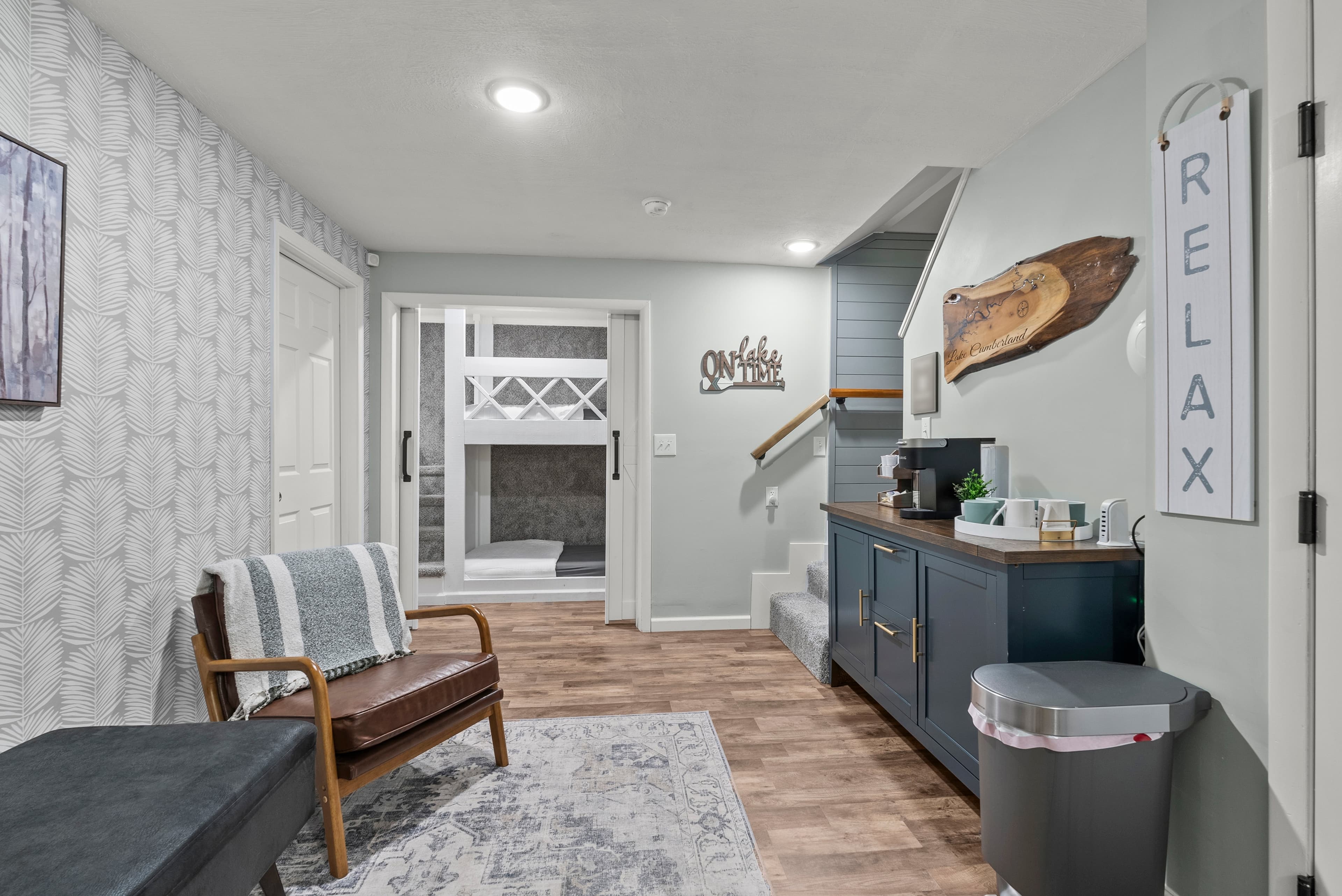 Two leather chairs offer a relaxing spot in the hub connecting bedrooms, bunk area, laundry,gameroom