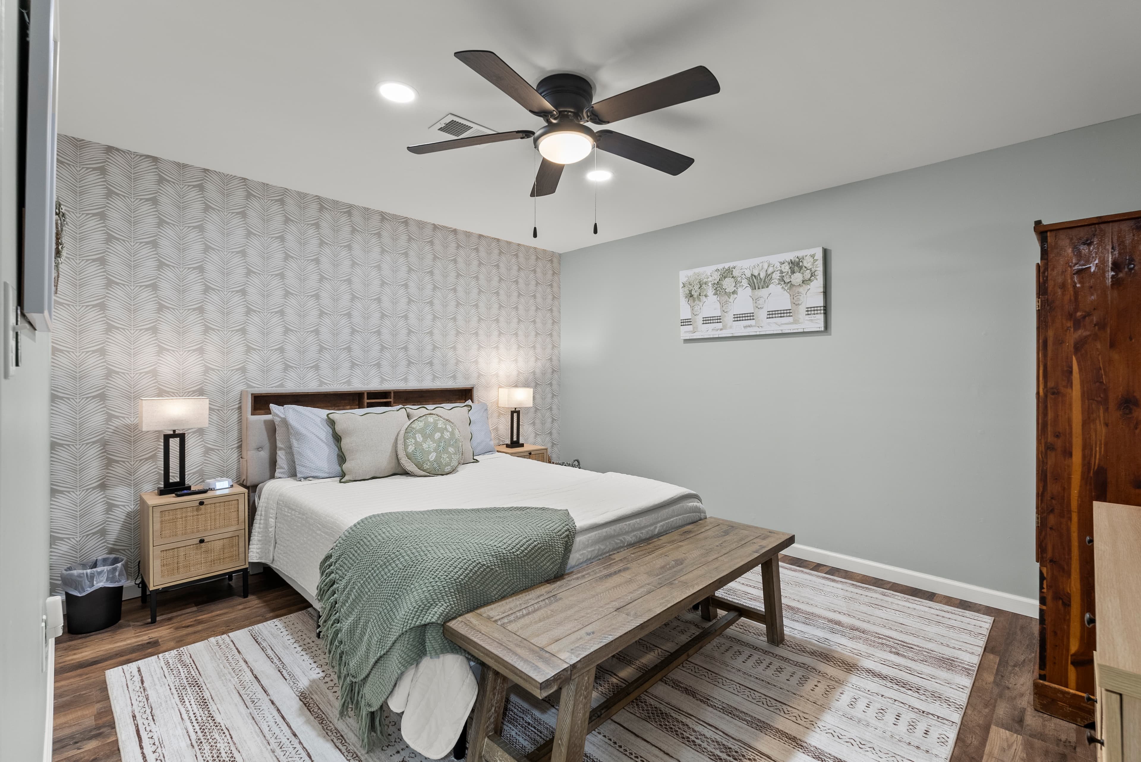 Lower level queen bedroom, w/nightstands, lamps, dresser, armoire & Roku TV. Next to bunk area. 