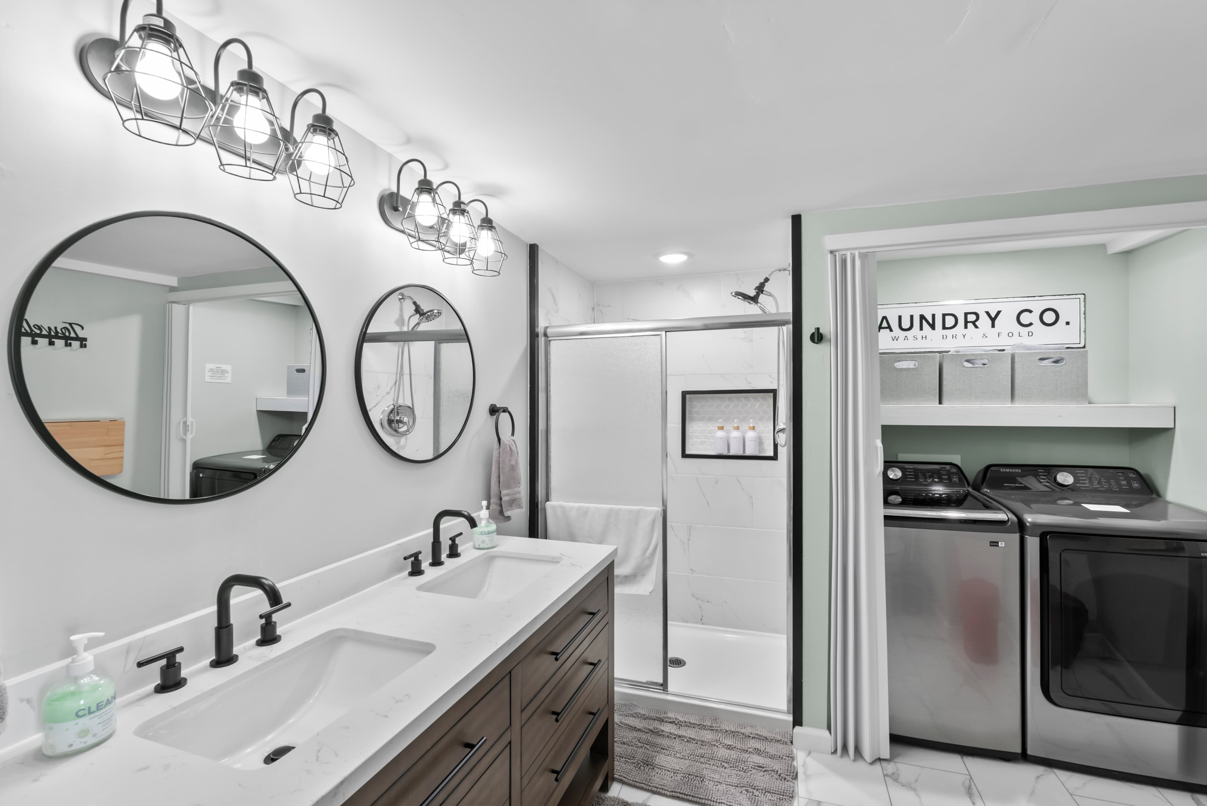 Downstairs full bathroom / laundry room. Walk in shower, folding table on wall for laundry.