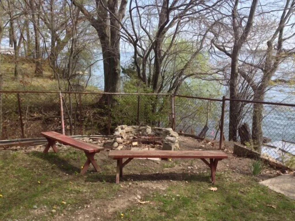 Firepit in corner of yard with lake views