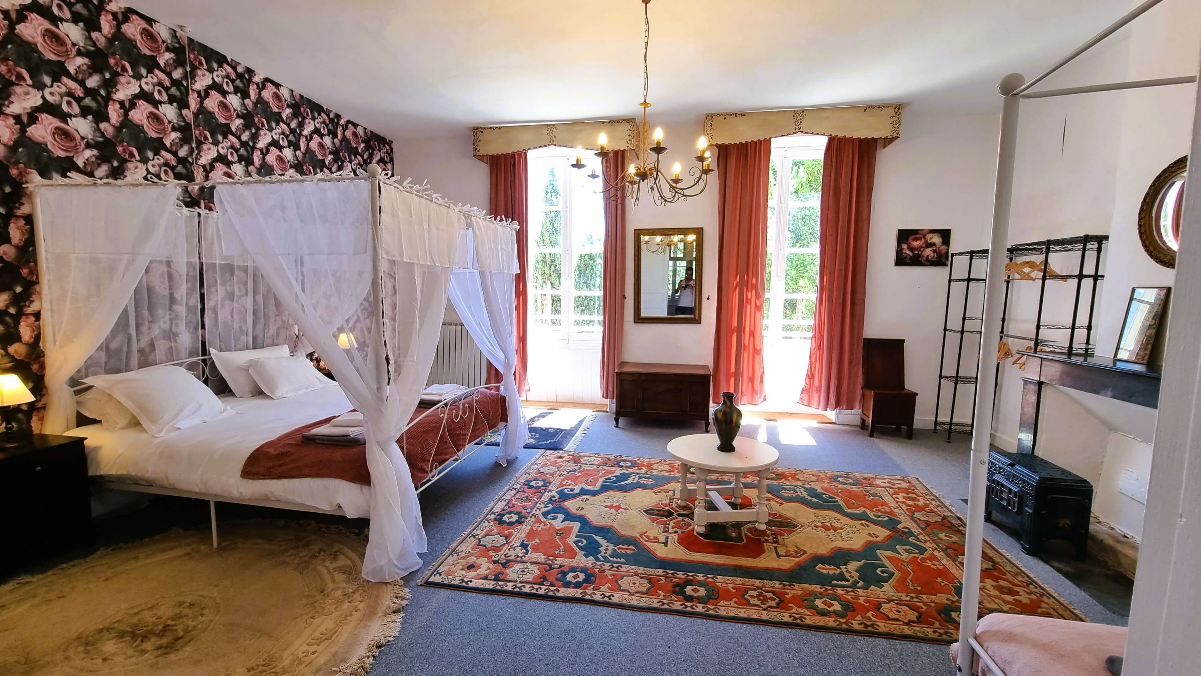 Room with four-poster bed and garden view